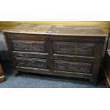 An unusual nineteenth century coffer chest having a carved facade with two drawers and a top with