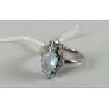 A modern diamond & blue stone floral ring with white metal setting Condition reports provided on