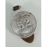 A white metal city of Cardiff bus or tram conductors badge, number 52 on leather strap