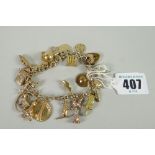 A yellow gold charm bracelet with numerous mainly if not all gold souvenir charms, 49grams total