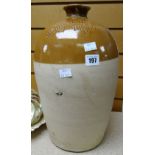 A turn of the century narrow neck stoneware bottle with impressed inscription 'This jar is the