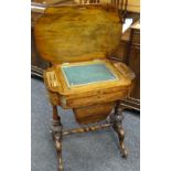 A nineteenth century walnut sewing table having a shaped top over a carved columnal base and with