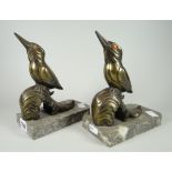 A pair of antique (believed) bronze kingfisher model bookends, perched on grey marble platform bases