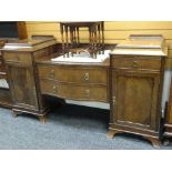 An Edwardian mahogany serpentine front break-top sideboard having two centre drawers, two flanking