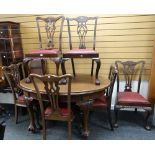 An Edwardian oval extending mahogany dining table on carved ball & claw supports together with three