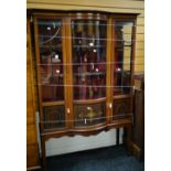 An Edwardian inlaid mahogany standing china cabinet with curved glass centre section and two