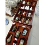 Two wooden displays of twentieth century Oriental miniature cloisonne vases and miniature Republican