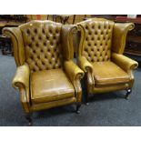 A pair of good studded and button back tan leather wingback armchairs Condition reports provided