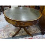 A REPRODUCTION REGENCY STYLE LIBRARY TABLE, the 111.5 cms diameter top with gilt tooled green