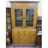 AN ANTIQUE WELSH OAK & PINE TWO PIECE CUPBOARD with Talwrn decoration, the upper section with twin