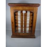 A THOMAS GURNEY MAHOGANY COLLECTOR'S CABINET of twenty six drawers with glazed front door, all