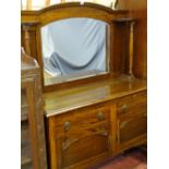 A POLISHED MIRROR BACKED SIDEBOARD the top having shelved pillars to a base of two drawers and two