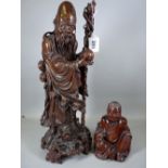 A WELL CARVED CHINESE WOODEN FIGURE OF SHOU LAO and one other, the Daoist God with his staff in