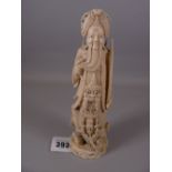 A 19th CENTURY CHINESE CARVED IVORY STANDING FIGURE OF A BEARDED MAN lifting his beard to expose a