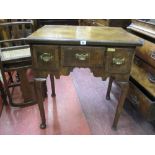 A GEORGE III WALNUT LOWBOY having a quarter cut veneered and crossbanded top over three