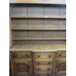 A 19th CENTURY ANGLESEY OAK & MAHOGANY BREAKFRONT DRESSER, the three shelf wide boarded rack with