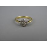 A LADY'S EIGHTEEN CARAT GOLD DIAMOND CLUSTER RING of seven small diamonds, 2.2 grms, size 'M'