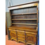 A LATE 19th CENTURY OAK & MAHOGANY WELSH DRESSER having a pierced and patterned hood over three