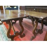 A NEAR PAIR OF CONTINENTAL WALNUT TABLES, the rectangular tops on lyre end supports and shaped under