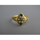 A LADY'S EIGHTEEN CARAT GOLD SEED PEARL & PERIDOT CLUSTER RING, 2.4 grms, size 'M/N'