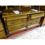A LATE VICTORIAN MAHOGANY SIDEBOARD of six drawers on substantial turned bun feet, 90 cms high