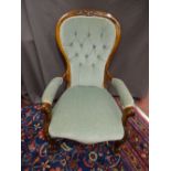 A VICTORIAN WALNUT SPOONBACK ARMCHAIR with carved detail and button back upholstery on brown pot