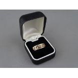 A NINE CARAT GOLD TWO COLOUR 'CARIAD' RING, 5.6 grms, size 'P'