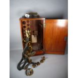 A SWIFT & SON VINTAGE BINOCULAR MICROSCOPE in a fitted mahogany case with lower drawer, lacquered