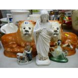 Pair of Staffs pottery recumbent lions with glass eyes, a composite figure of Christ and two pottery