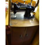 Singer sewing machine in a wooden storage/work table case