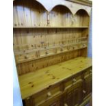 Pine dresser with five spice drawer top and the base having three drawers over three base cupboards