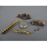 Four Victorian bar brooches in fifteen carat gold and other metals, one having garnet type