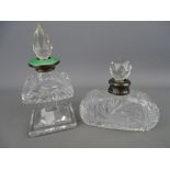 Two cut glass scent bottles with facet cut stoppers and silver collars