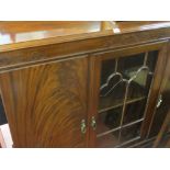 Early to mid 20th Century mahogany railback standing china cabinet having a centre glazed door