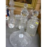 Cut glass ship's type decanter and three further glass decanters with ceramic drinks labels
