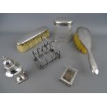 Mixed selection of hallmarked silver items including a small four section toast rack, pepper pot,