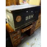 A vintage painted pine cabin trunk bearing old passenger-line labels together with a vintage desk