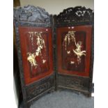Japanese Meiji-period folding hardwood screen carved with birds, foliage with twin panels of bone