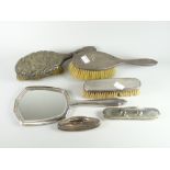 A matching machine turned silver backed dressing table mirror and brush, two further silver backed