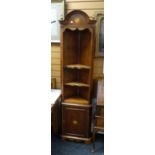 A reproduction standing mahogany narrow corner unit with cupboard base and open shelf top having