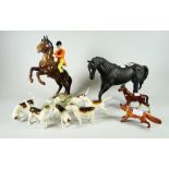 A Beswick model of a rearing mounted huntsman with seperate fox and six hounds together with a