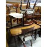 An Edwardian mahogany extending wind out dining table (winder with us) together with six chairs,