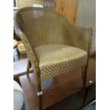 A golden coloured Lloyd Loom cushion seated chair Condition reports provided on request by email for