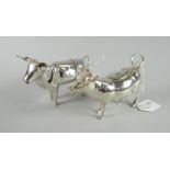 A pair of continental Schuppe-style silver creamers in the form two horned calves with loop tails as