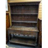 Antique oak narrow dresser having boarded rack back above two-drawer pot-board base raised on