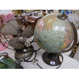 A vintage terrestrial spinning table globe and a vintage electric desk fan by Frost (distressed)