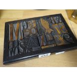 A framed arrangement of printers blocks including a copper mounted pointing finger, 21 x 14cms (