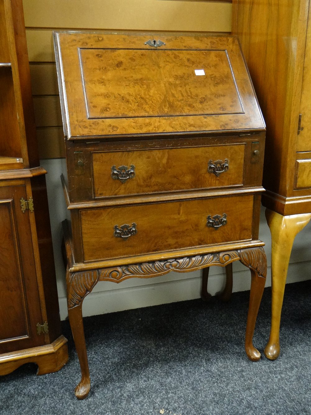 An antique reproduction burr wood sloped compact bureau with two drawers and carved base, 53cms wide - Image 2 of 2