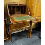 An antique reproduction burr wood sloped compact bureau with two drawers and carved base, 53cms wide
