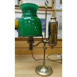 A vintage brass reading oil lamp with elevated side reservoir and green glass shade Condition